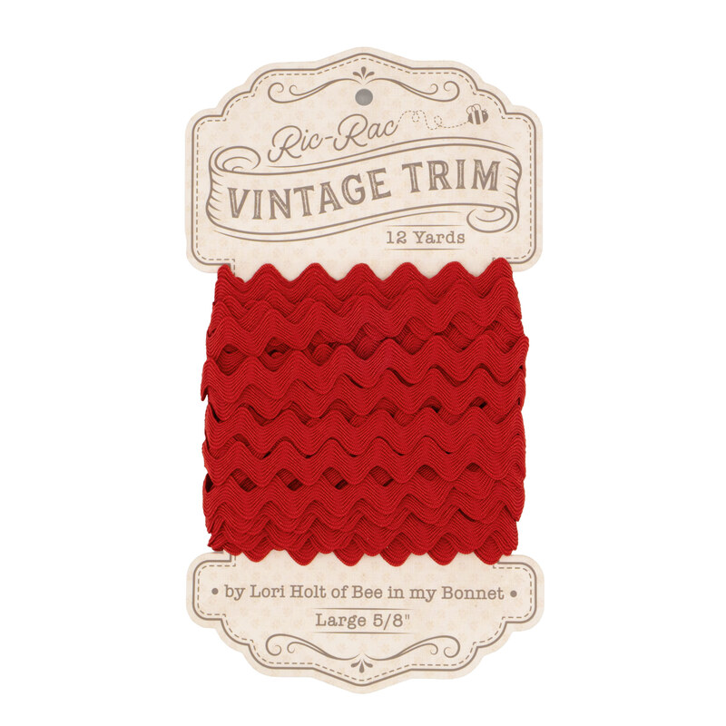 red ric-rac trim on ins cardboard packaging, isolated on a white background.