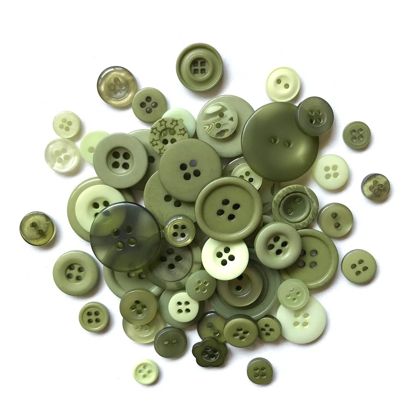 A pile of green buttons in a variety of sizes.