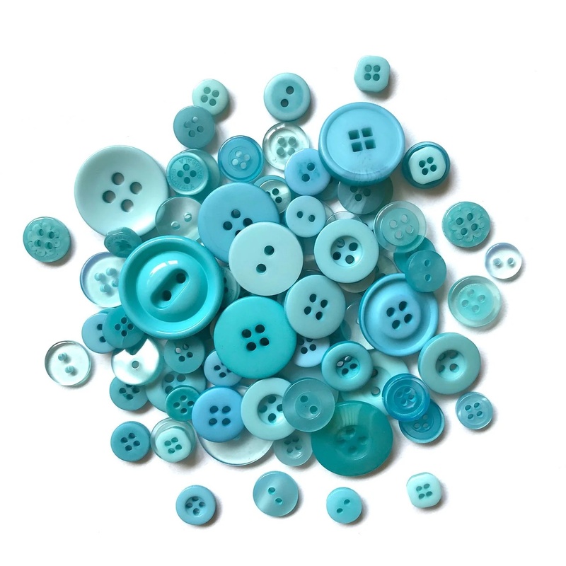 A pile of teal blue buttons in a variety of sizes.
