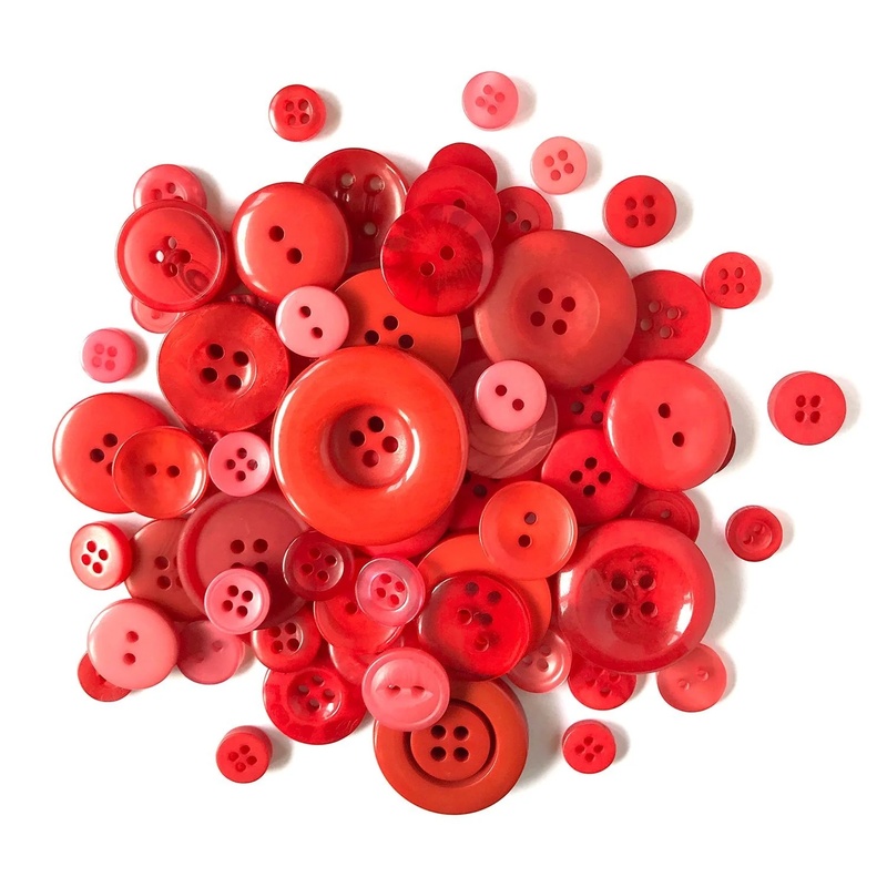 A pile of red buttons in a variety of sizes.