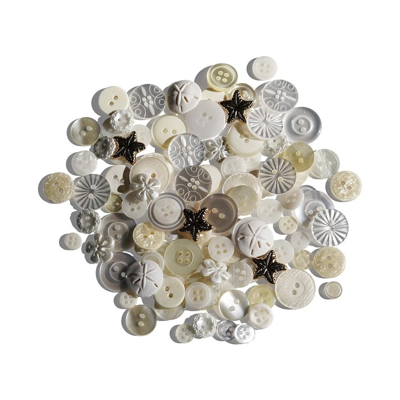 A scattered collection of various ivory buttons in different sizes and styles.