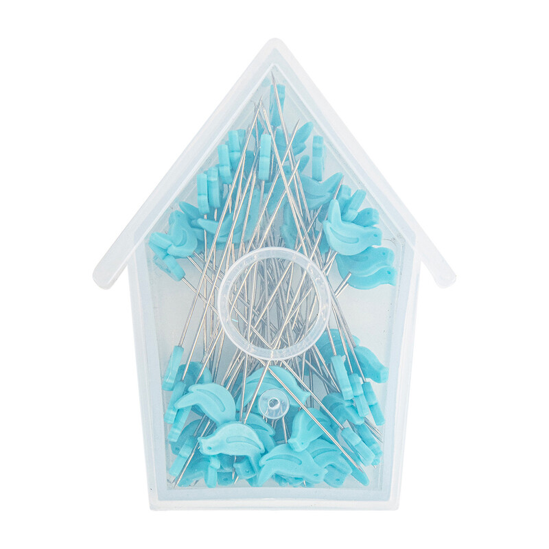 The blue bird pins in a plastic, birdhouse shaped box, isolated on a white background.
