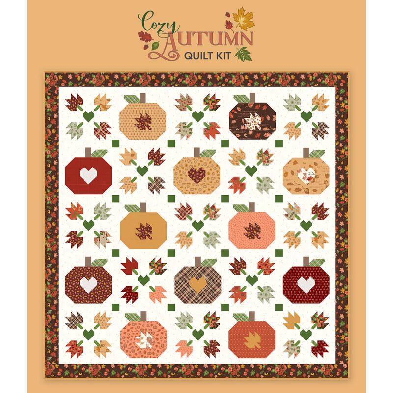 Digital mockup of the Cozy Autumn quilt featuring patchwork pumpkins, falling leaves, and hearts, set against a warm brown background with a logo at the top.
