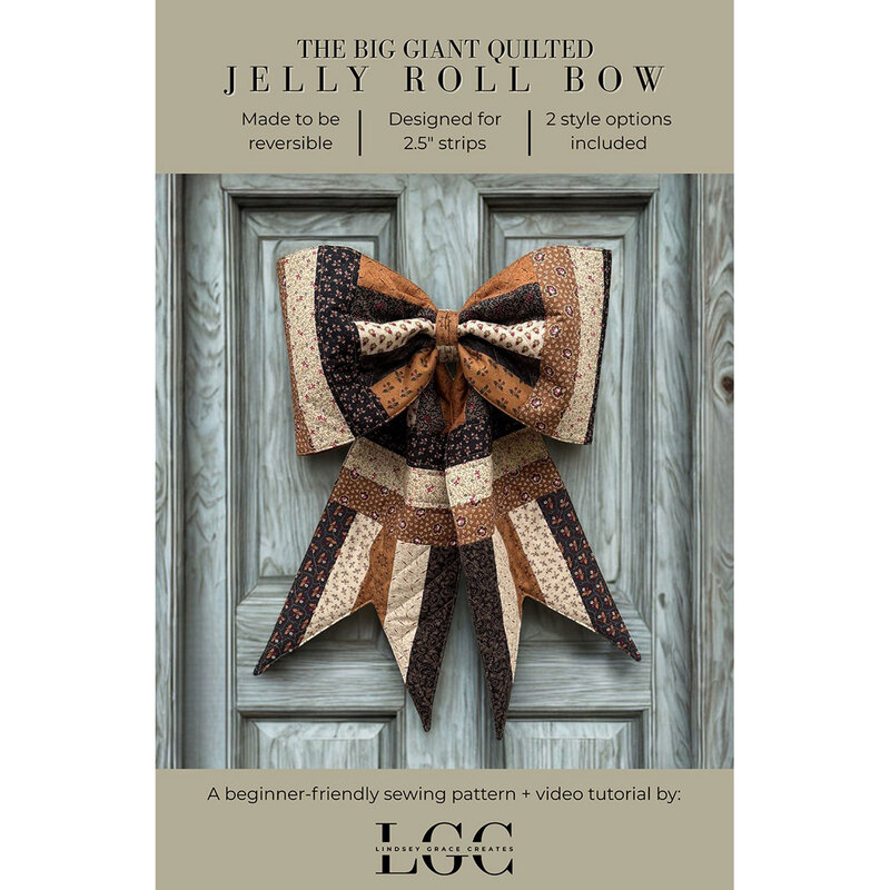 The finished jelly roll bow in brown hanging on a gray wooden door with the title of the pattern in a banner above, and the pattern designer below.