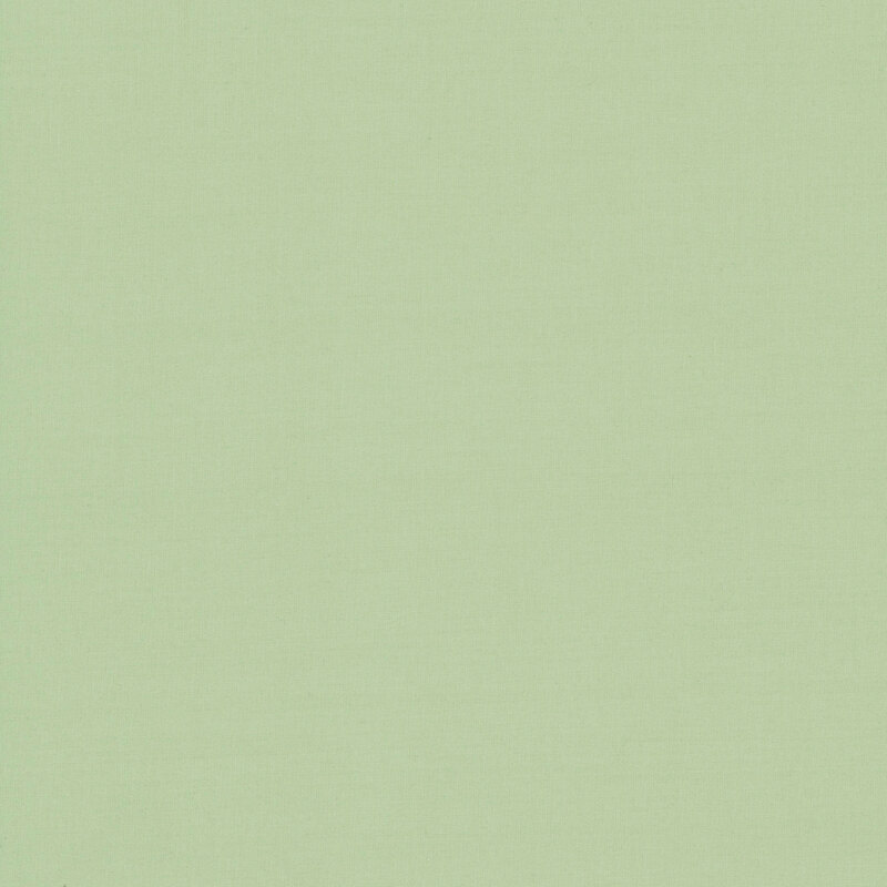 Sage green fabric with a solid design, making it perfect for coordinating with a variety of projects.