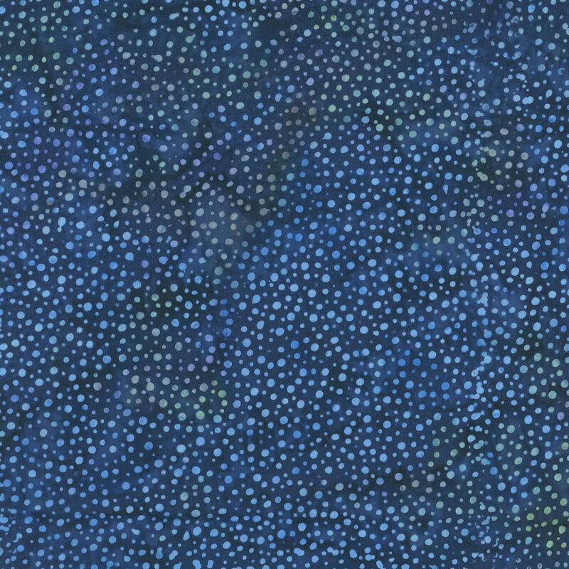  A mottled dark royal blue batik fabric with scattered light blue dots.