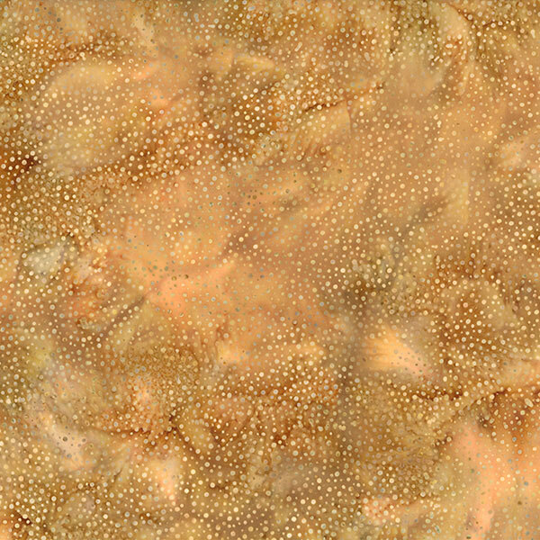 A mottled ginger brown batik fabric with scattered light brown dots.