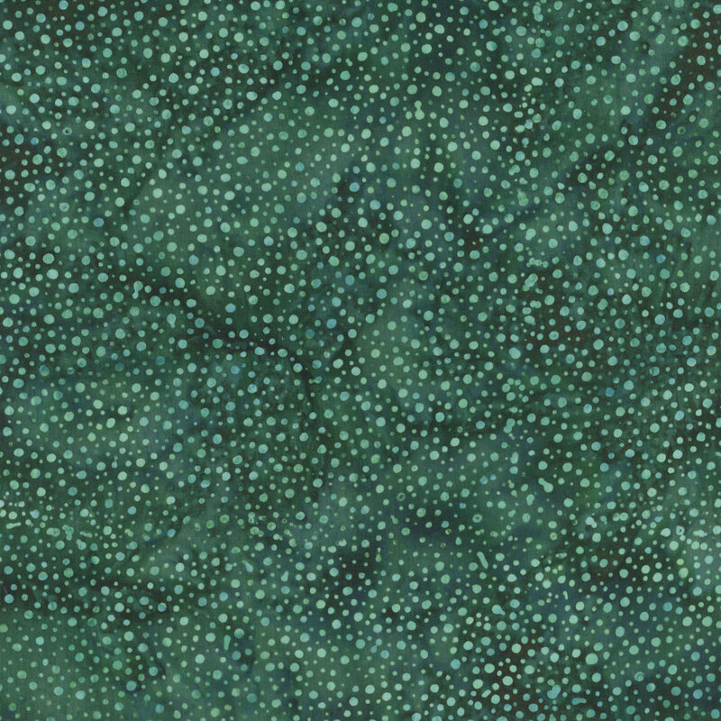 A mottled dark eucalyptus batik fabric with scattered light teal dots.