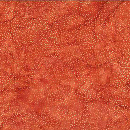 A mottled marmalade orange batik fabric with scattered light orange dots.