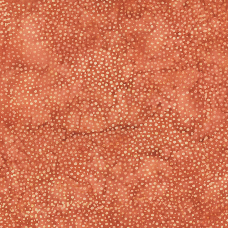 A mottled marmalade orange batik fabric with scattered light orange dots.