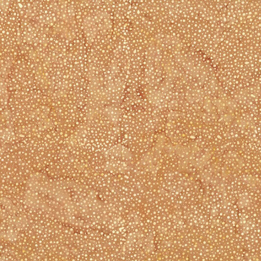 A mottled tan batik fabric with scattered tonal dots.