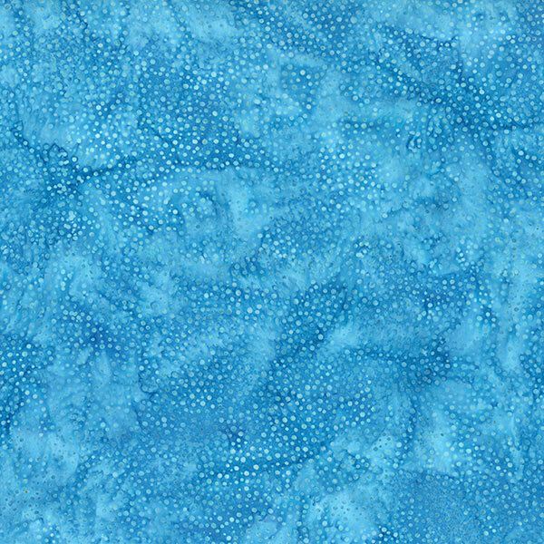 A mottled ocean blue batik fabric with scattered tonal dots.