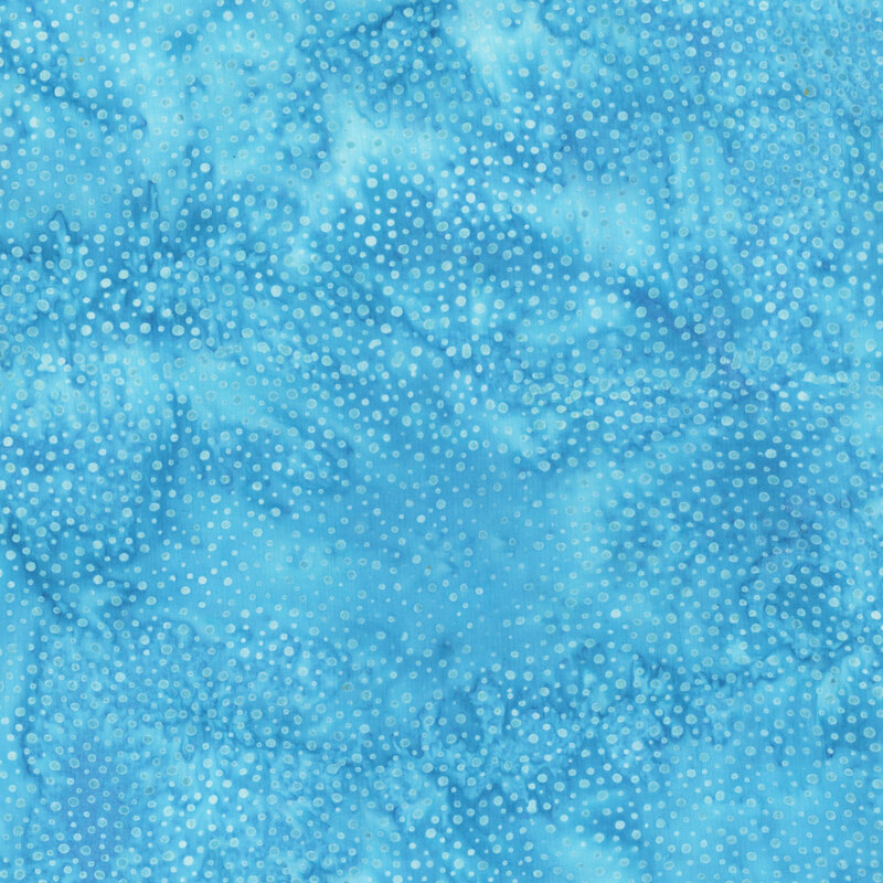 A mottled ocean blue batik fabric with scattered tonal dots.