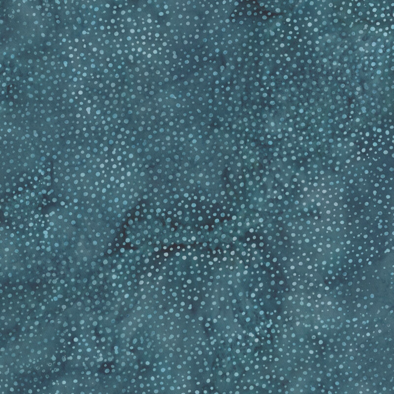A mottled dark teal blue batik fabric with scattered light teal dots.
