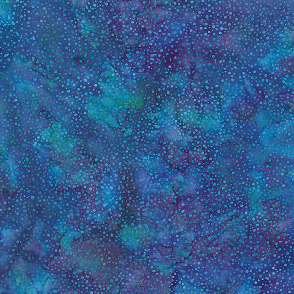 A mottled lapis blue batik fabric with scattered blue dots.