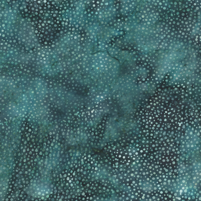 A mottled dark teal and black batik fabric with scattered teal dots.