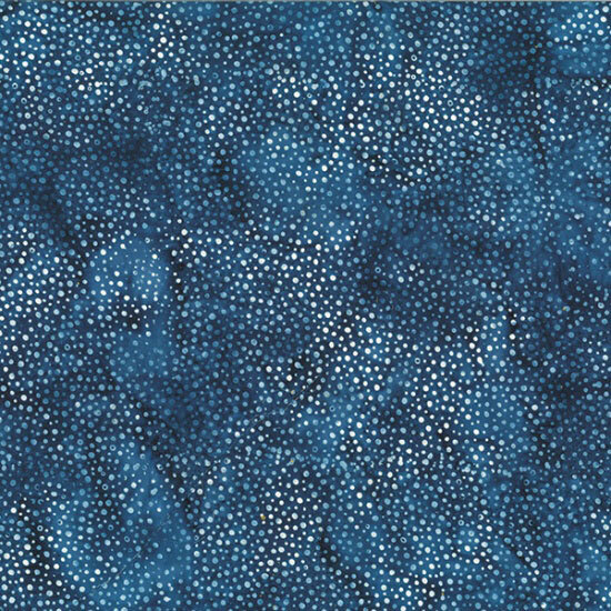 A mottled navy blue batik fabric with scattered light blue dots.