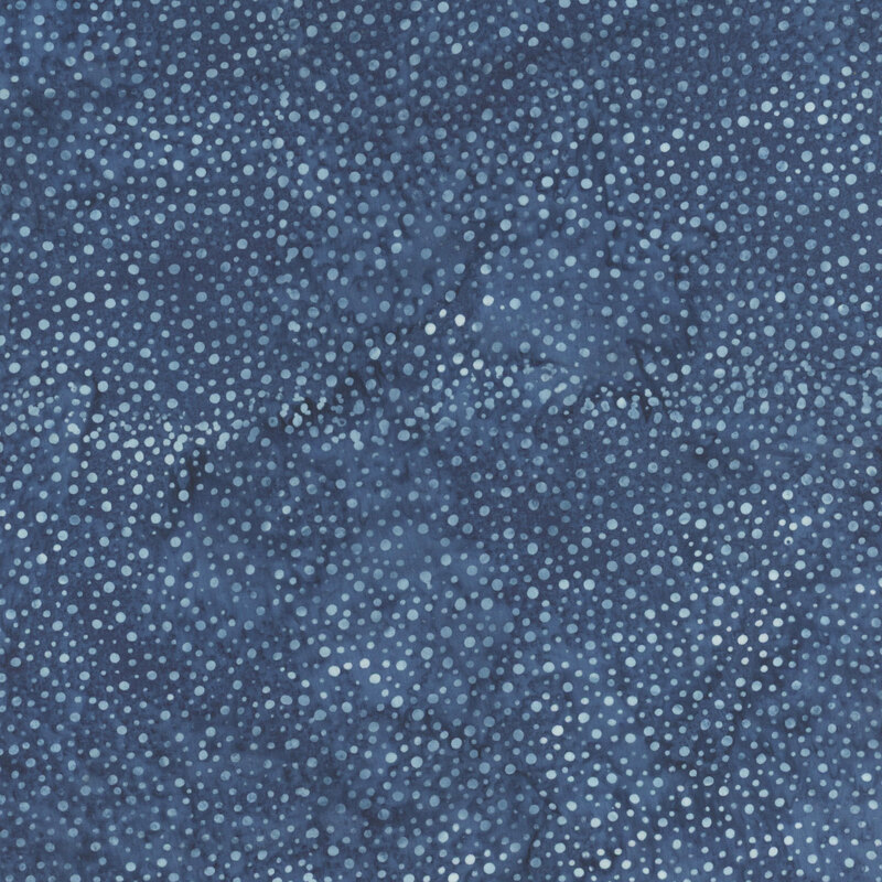 A mottled navy blue batik fabric with scattered light blue dots.