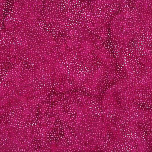 A mottled bright fuchsia batik fabric with scattered light pink dots.