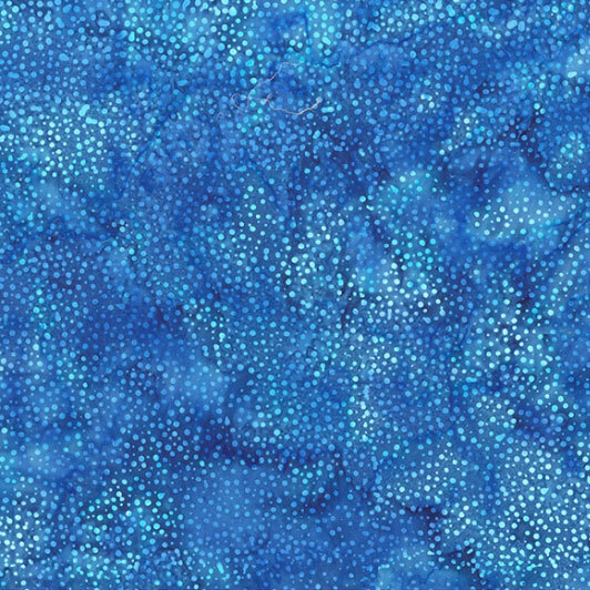 A mottled sapphire blue batik fabric with scattered light blue dots.