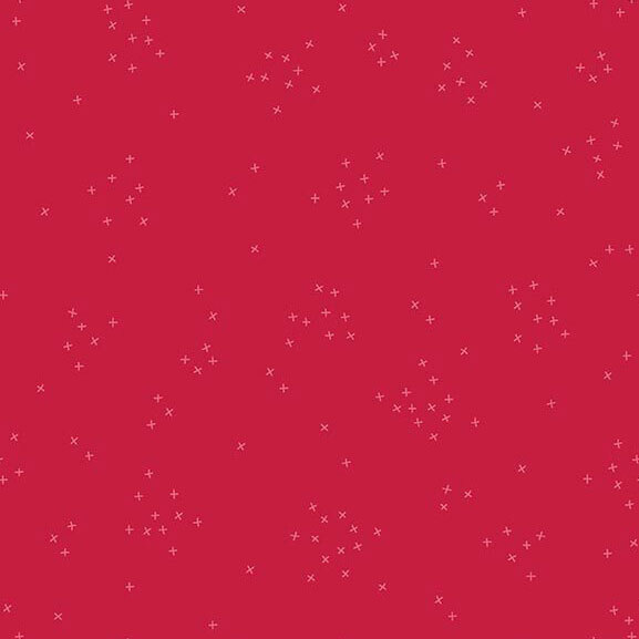 This bright fuchsia pink fabric is scattered with tiny crosses clustered together.