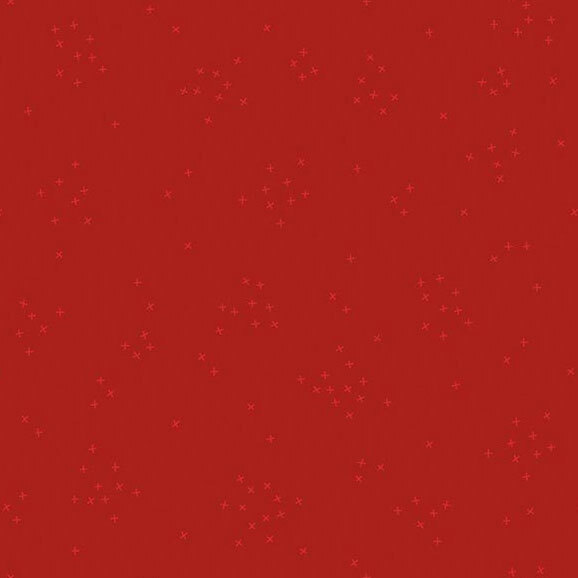 A crimson red fabric with scattered with tiny crosses clustered together.