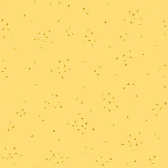 This chiffon yellow fabric is scattered with tiny tonal crosses clustered together.