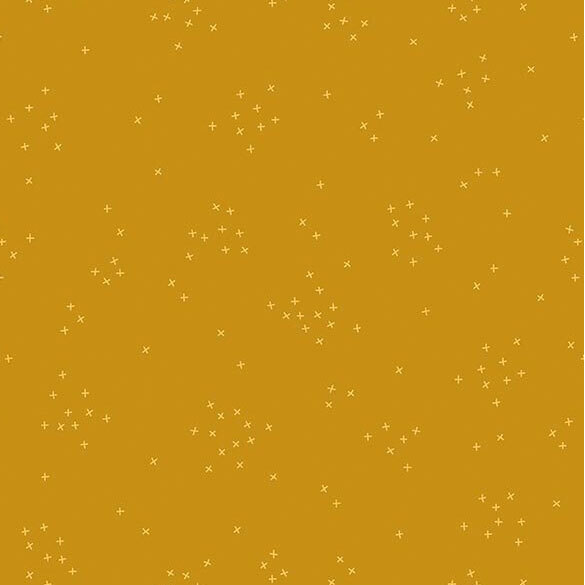 This butterscotch fabric is scattered with tiny crosses clustered together.