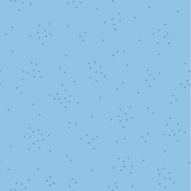 A baby blue fabric with scattered with tiny tonal crosses clustered together.