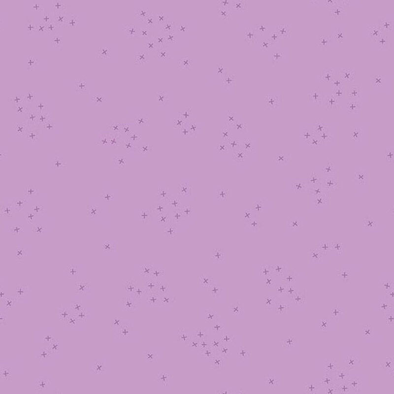 This lilac fabric is scattered with tiny tonal crosses clustered together.