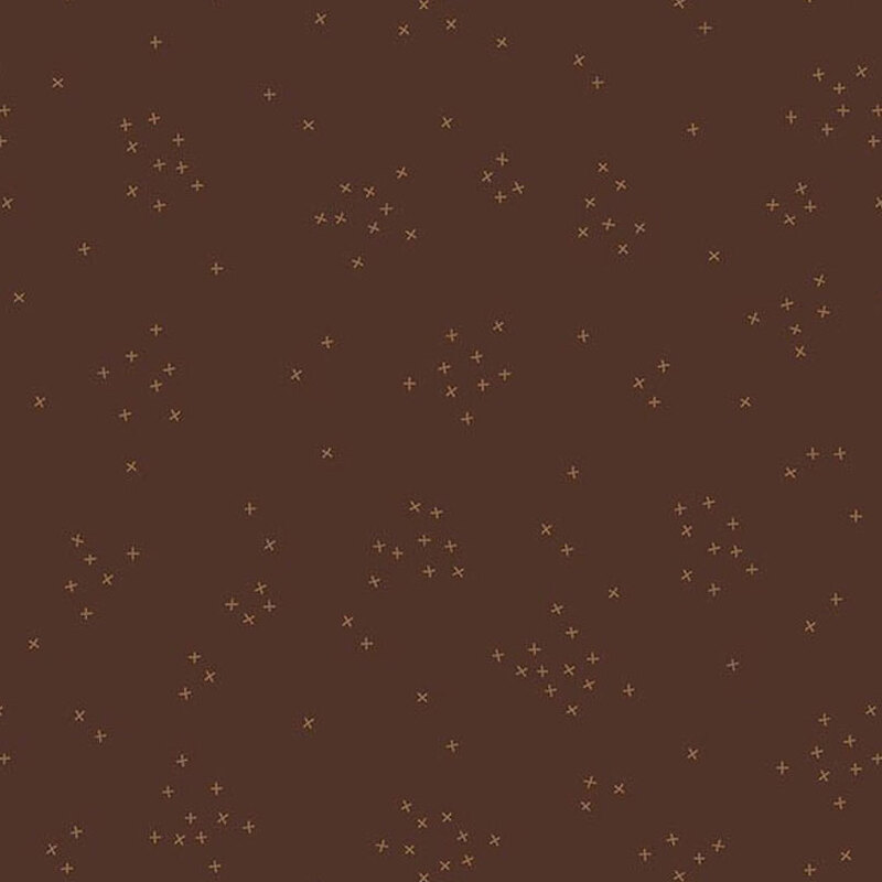 This brown fabric is scattered with tiny crosses clustered together. 