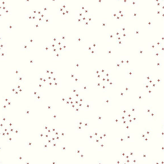 This white fabric is scattered with tiny red crosses clustered together.