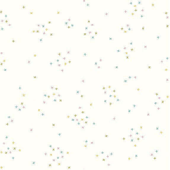 This white fabric is scattered with tiny pastel crosses clustered together.