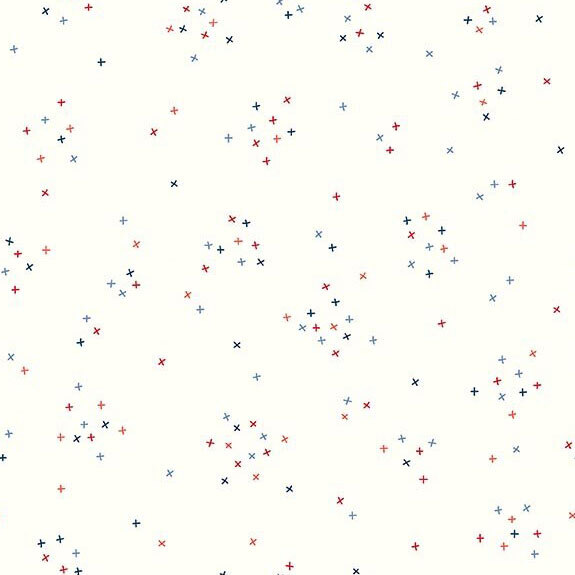 This white fabric is scattered with tiny red, white, and blue crosses clustered together.