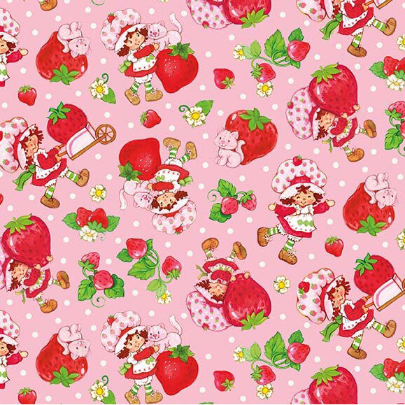 A pink fabric with tossed motifs of Strawberry Shortcake, Custard the cat, and giant strawberries. 