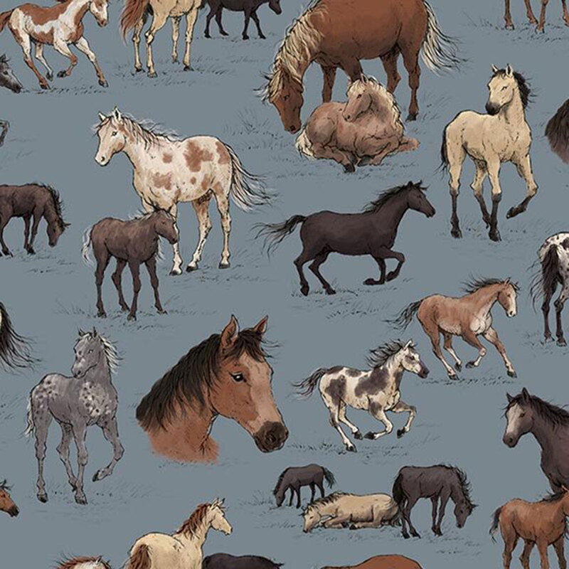 Denim blue fabric with an array of horses and foals in tan, gray, and black