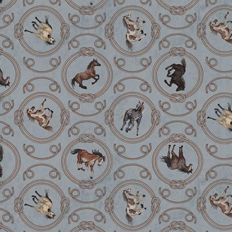 Textured denim blue fabric featuring a pattern of horses within ornamental rope medallions