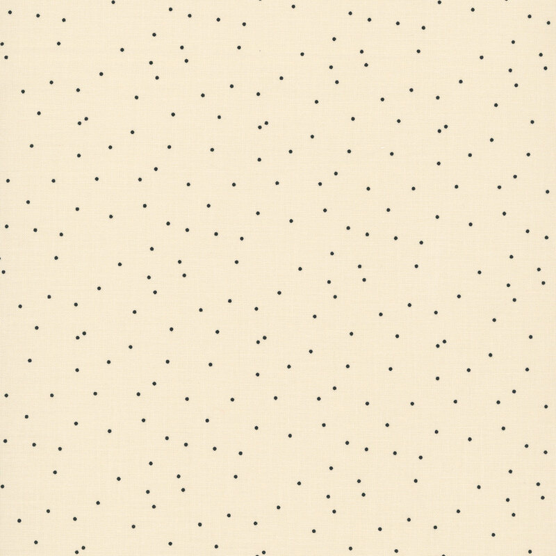 Cream fabric featuring a scattered black polka dot print.