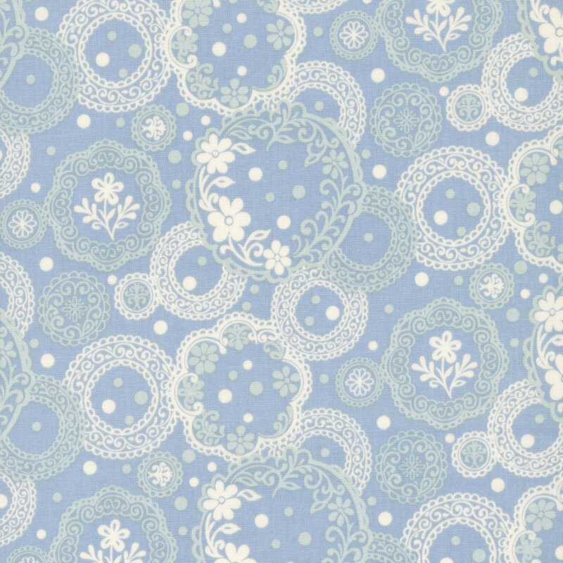 Ornate pattern of pale aqua and ivory circular medallions filled with lace-like details, florals, and dotted accents on a pale blue background.