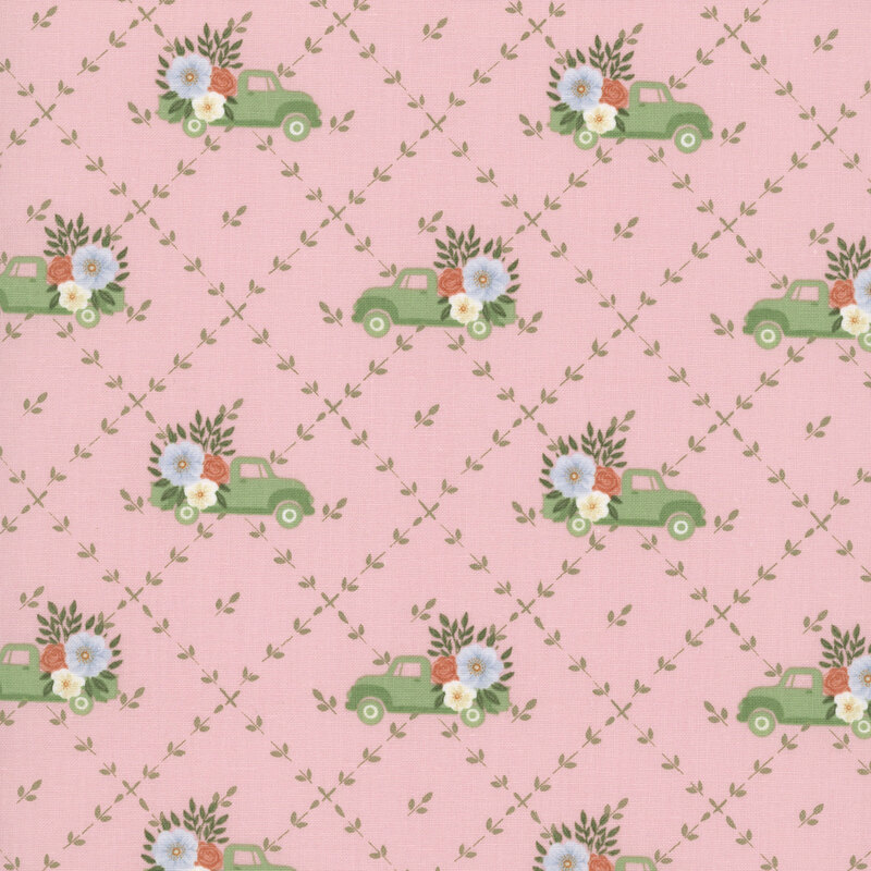 A blush fabric with a green floral lattice pattern featuring green vintage trucks with floral bouquets in the back.