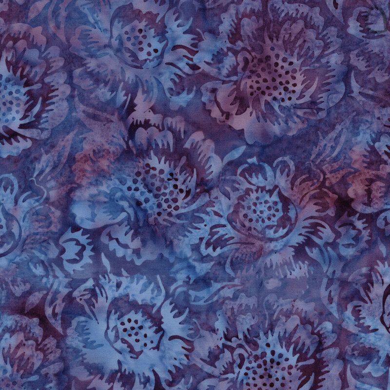 A mottled blue purple batik fabric with large flowers. 