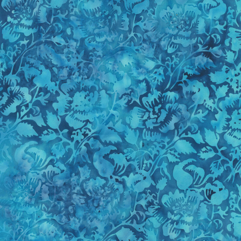 Mottled azure batik fabric with tonal flowers and vines. 