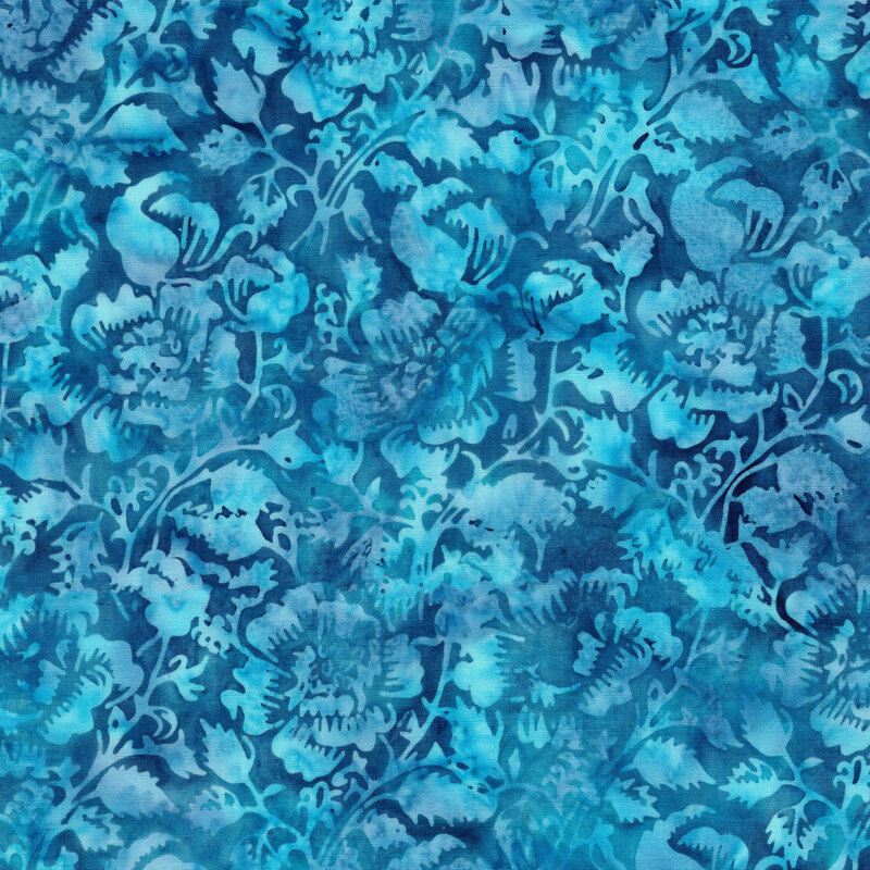 A mottled azure batik fabric with tonal flowers and vines. 