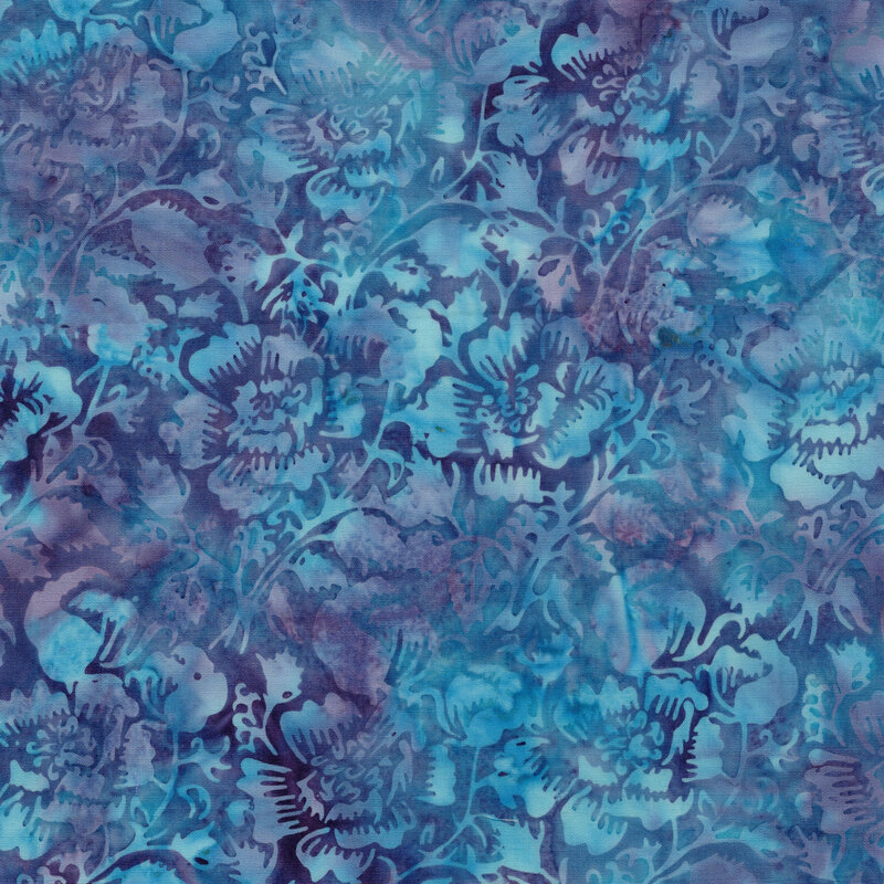 A mottled azure and purple batik fabric with flowers and vines. 