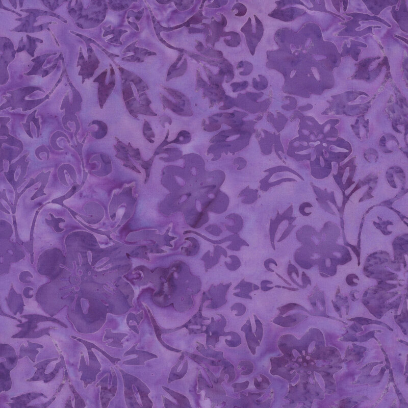 Mottled grape purple batik fabric with tonal flowers and leaves. 