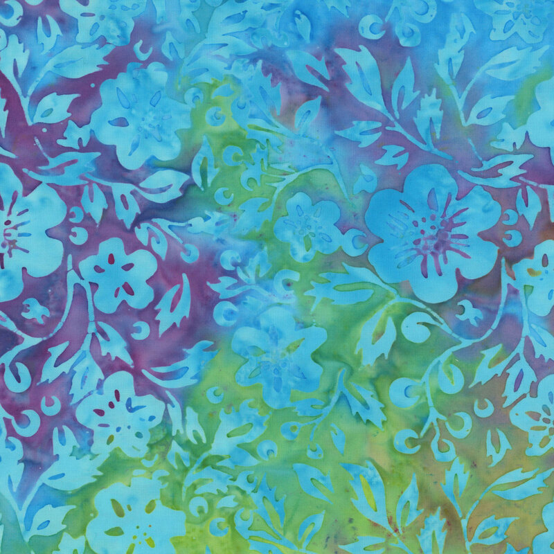 A mottled lime green and magenta batik fabric with ocean blue flowers and vines. 