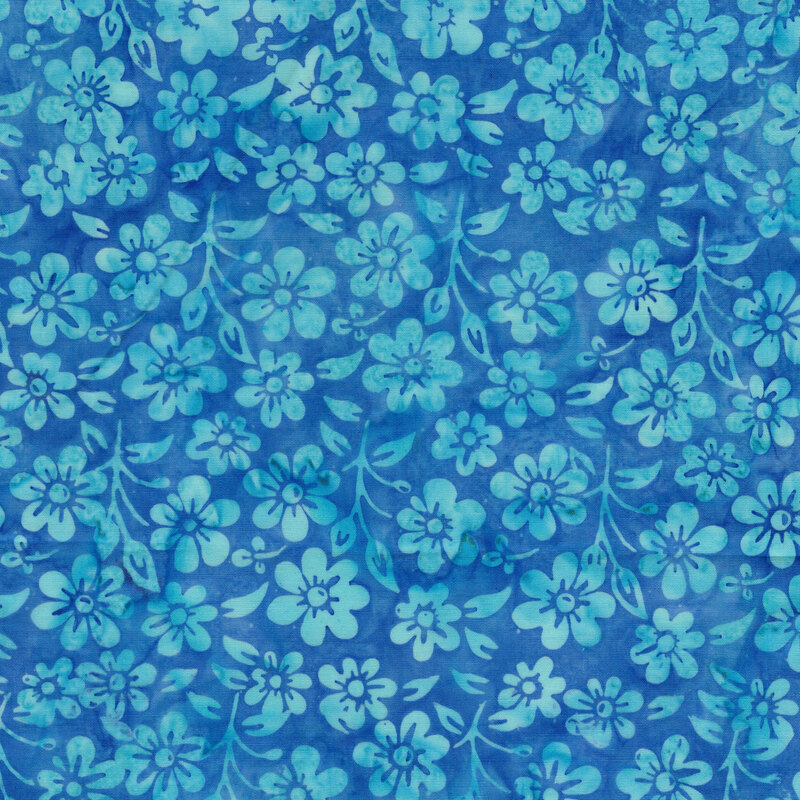 A mottled ocean blue batik fabric with tonal flowers and sprigs. 