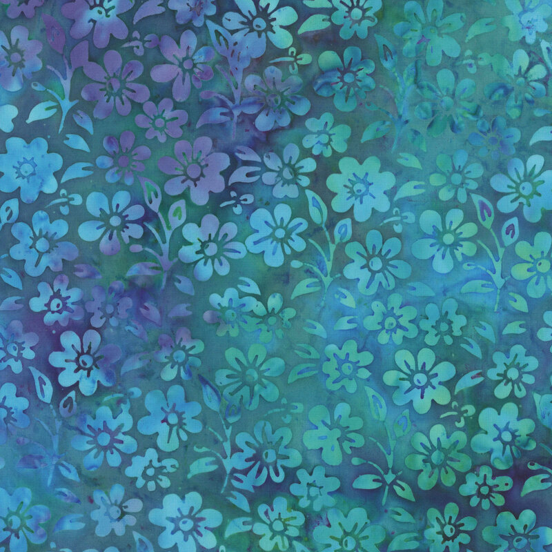 A mottled ocean blue and muted violet batik fabric with flowers and sprigs. 