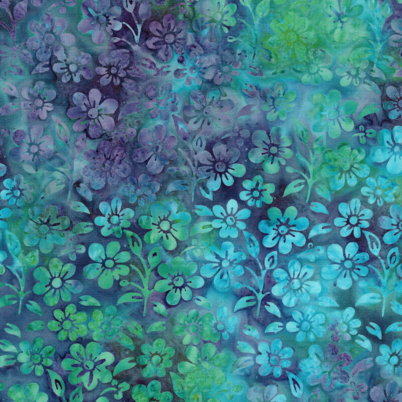 A mottled lime green, ocean blue, and muted violet batik fabric with flowers and sprigs. 