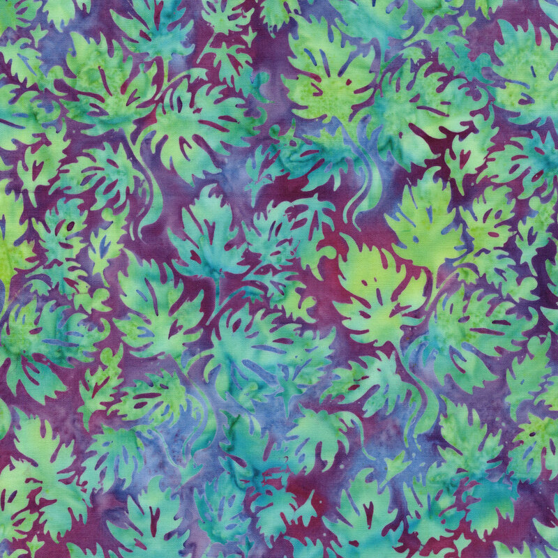 A mottled plum and dark teal batik fabric with lime green leaves. 